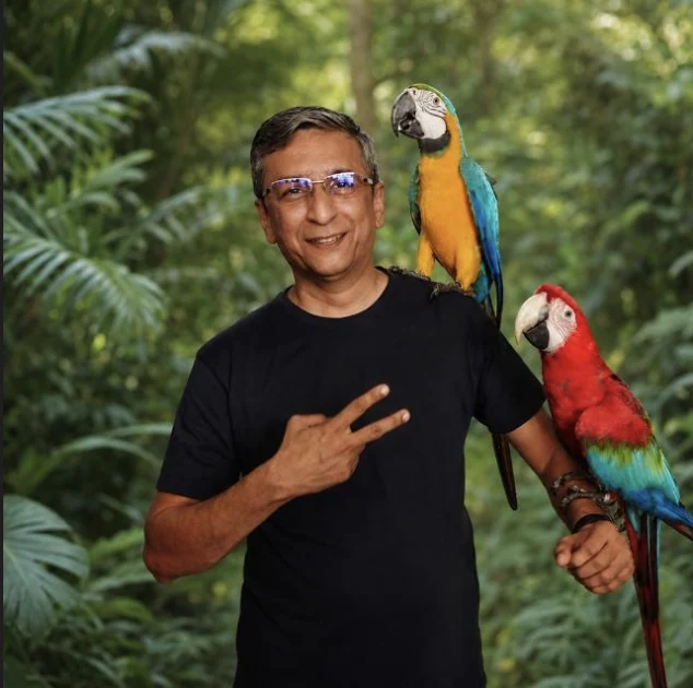 Dr Shailesh Pethe with two macaws